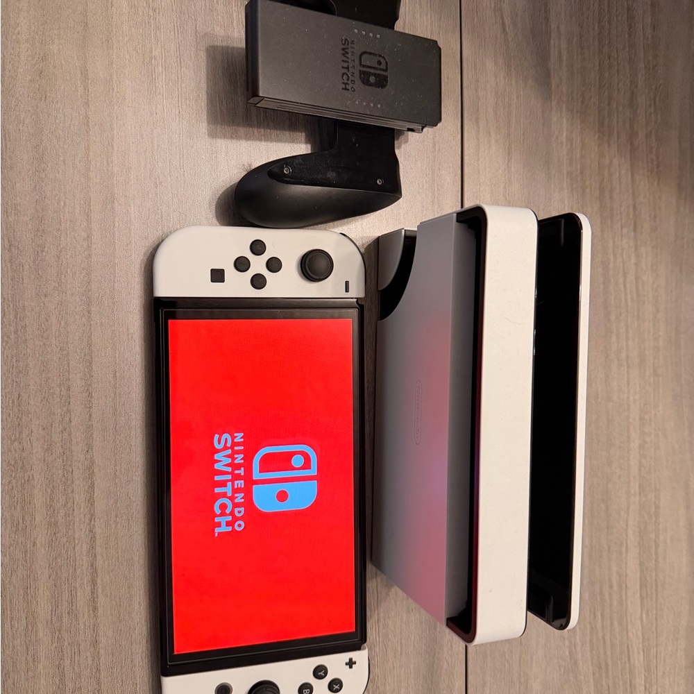 Nintendo Switch OLED in White with Accessories barely used.